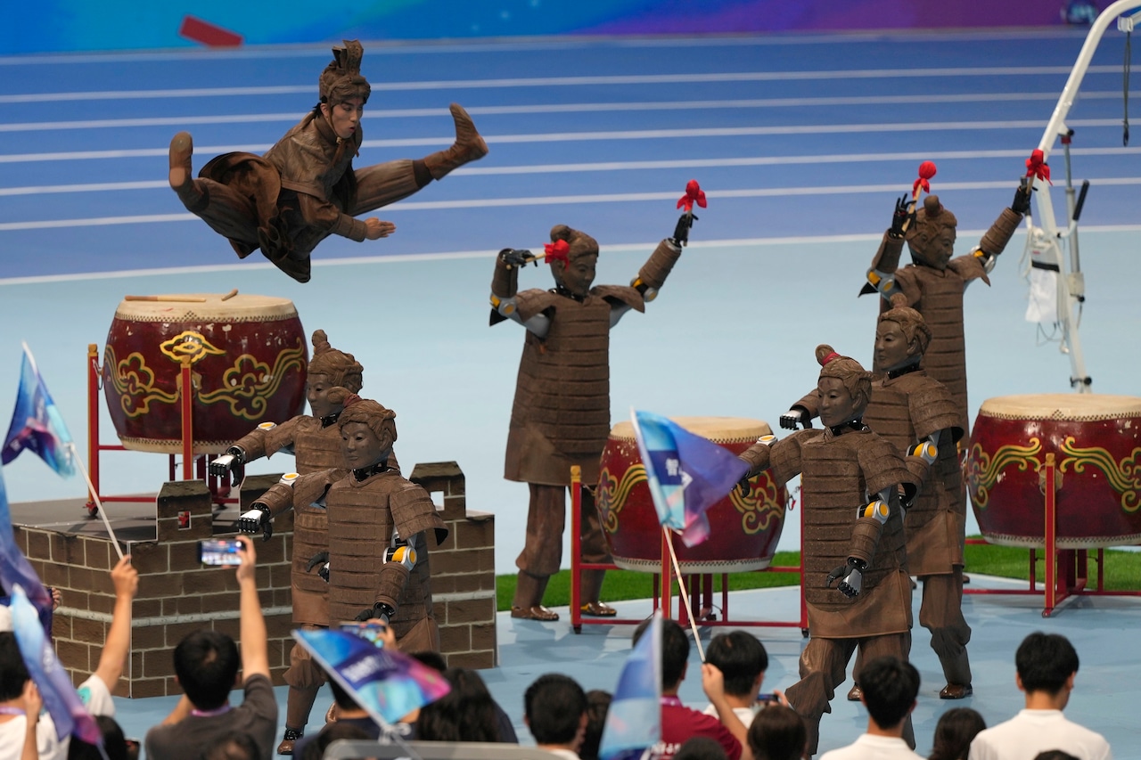 Humanoid robots performing Chinese martial arts on stage